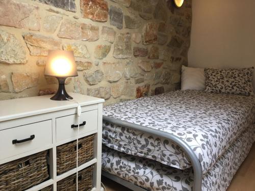 a bedroom with a bed and a lamp on a dresser at Baronheid in Francorchamps