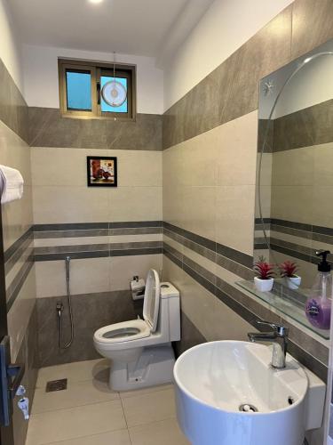 a bathroom with a toilet and a sink at Ortus - Murree Hills in Murree