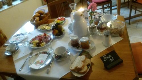 a table with plates of food on a table at Wirtshaus Gruber Weitenegg in Emmersdorf an der Donau