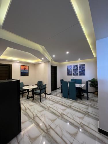 a lobby with tables and chairs in a building at Ortus - Murree Hills in Murree
