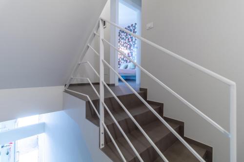 a staircase with a metal railing in a house at La Dimora della Luna in Pozzallo