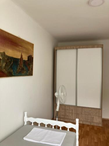 a bedroom with a bed and a large window at Apartman Jelena in Mostar