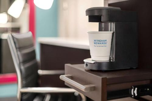a coffee cup sitting on top of a table at La Quinta Inn by Wyndham Columbus Airport Area in Columbus