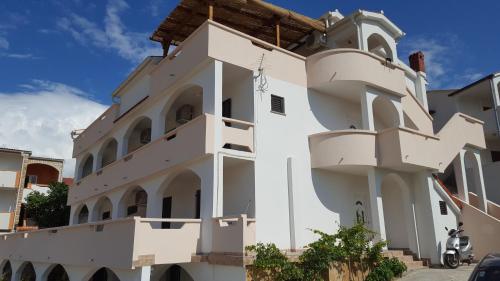 a white building with a church at Apartments and rooms with parking space Metajna, Pag - 4120 in Metajna