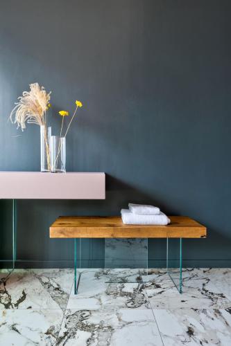 a table with a vase of flowers on top of a wall at Vulcano Palace in Castro