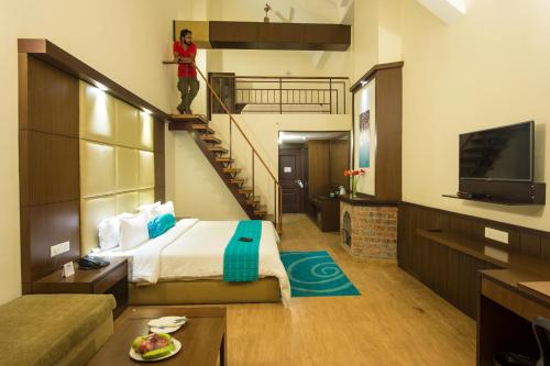 a hotel room with a bed and a tv at Sinclairs Retreat Kalimpong in Kalimpong