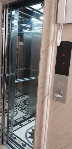 a glass elevator in a building with a sign on it at Chiến Thắng victory hotel in Ha Long
