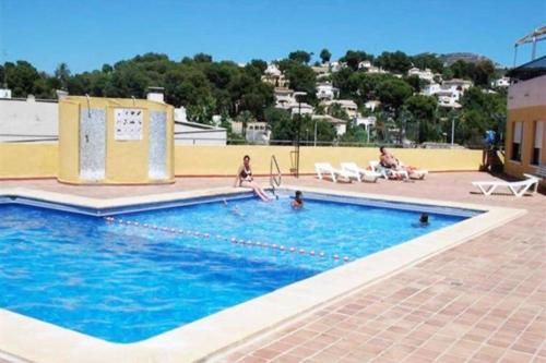 a swimming pool with people playing in the water at Casita Amigo in Moraira