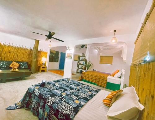 a bedroom with a bed and a living room at Chi-Bu Riverside in Nhơn Trạch