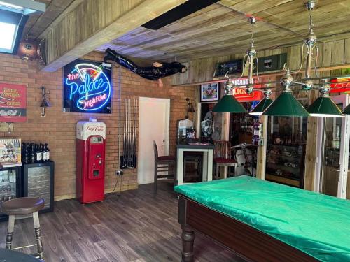 a bar with an old soda machine in a bar at Hatters Hotel in Skegness