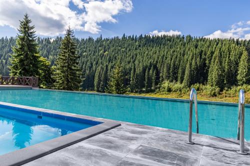 a swimming pool with a view of a mountain at Красна Поляна Family Club Resorts in Bukovel