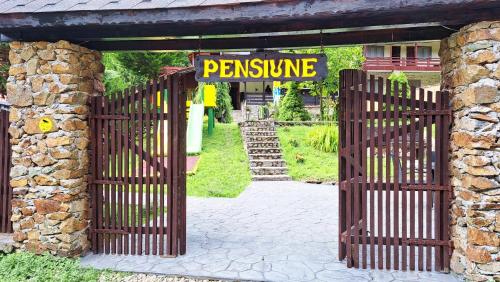 an entrance to a gate with a sign that reads permission at Hanul Vanatorului in Gureni