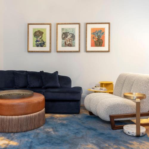 a living room with a blue couch and a table at Virgin Hotels Edinburgh in Edinburgh