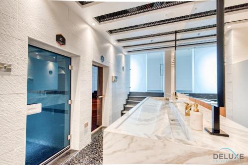 a lobby with a large glass door and stairs at Classy 1BR at Bayz by Danube Business Bay by Deluxe Holiday Homes in Dubai