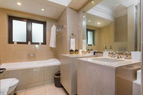 bagno con 2 lavandini, vasca e servizi igienici di Souk Al Bahar Al Tajer, Burj Khalifa - Mint Stay a Dubai