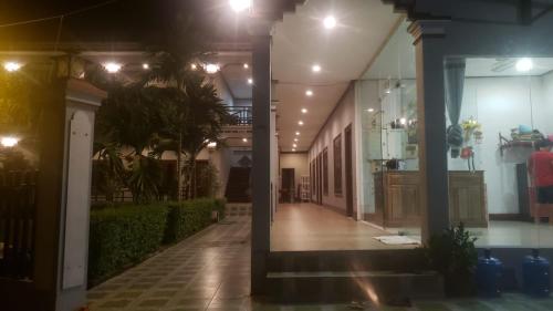 a hallway of a house at night with lights at Mama Leurth Sunset Guesthouse in Don Det