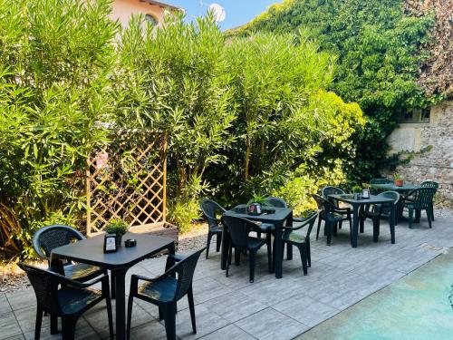 a group of tables and chairs on a patio at Hotel Al Bosco in Sona