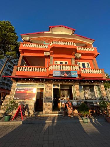 an orange building with a store in front of it at Guest House Rusalka in K'obulet'i