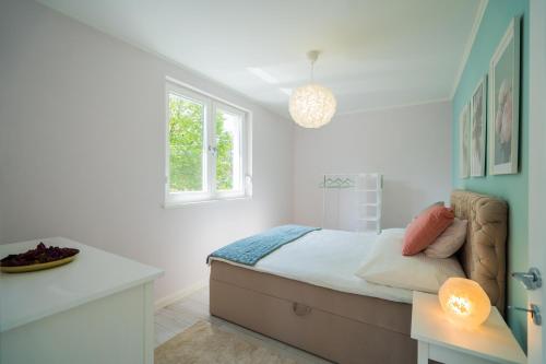a bedroom with a bed with a desk and a window at Harmony Boutique Villa in Siófok