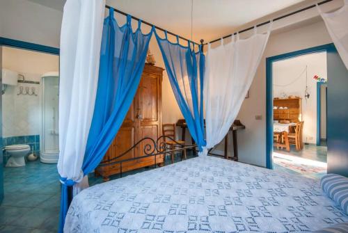 a bedroom with a bed with a canopy at La Ripa - Appartamento Il Fienile in San Gimignano