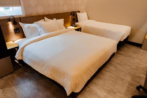 Uma cama ou camas num quarto em Tru By Hilton Criciúma