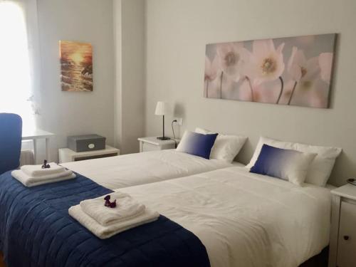ein Schlafzimmer mit 2 Betten und Handtüchern darauf in der Unterkunft El Angliru 3 con Wifi Incluido in Castandiello