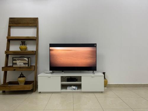a flat screen tv sitting on a white entertainment center at [METRO] Premium Location Lovely 2 Bedroom In JLT in Dubai