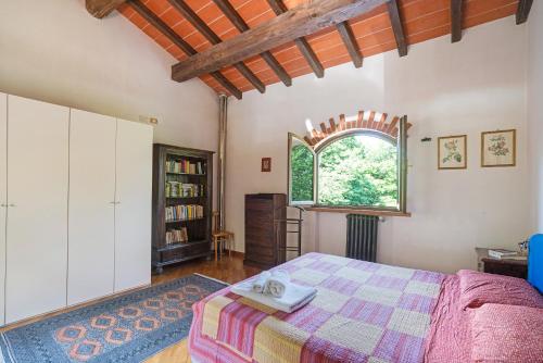 a bedroom with a large bed and a window at Casamasa in Mulazzo