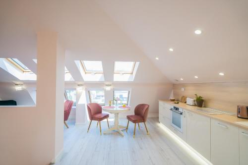 a kitchen with a table and chairs in a room at Harmony Boutique Villa in Siófok