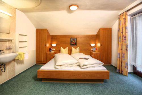 ein Schlafzimmer mit einem Bett und einem Waschbecken darin in der Unterkunft Appartement Kathi Scheiber in Sölden