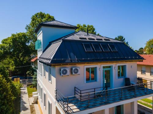 a house with solar panels on the roof at Harmony Boutique Villa in Siófok