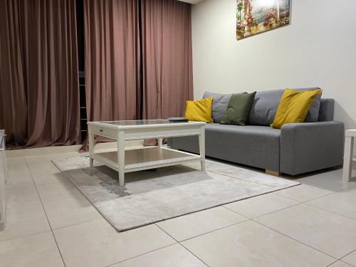 a living room with a couch and a table at METRO Premium Location Spacious 2 Bedroom Apartment Right Next to the Metro in Dubai