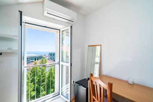 a window in a room with a desk and a window with a view at Rooms Nina in Dubrovnik