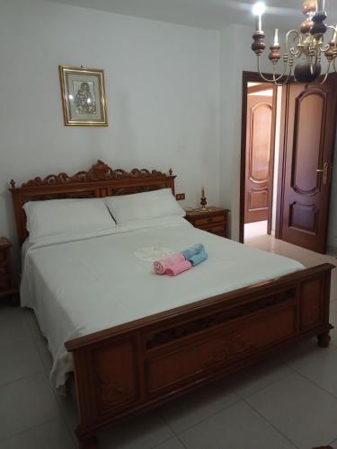 a bed with two towels sitting on top of it at Il Salvatore in Masainas