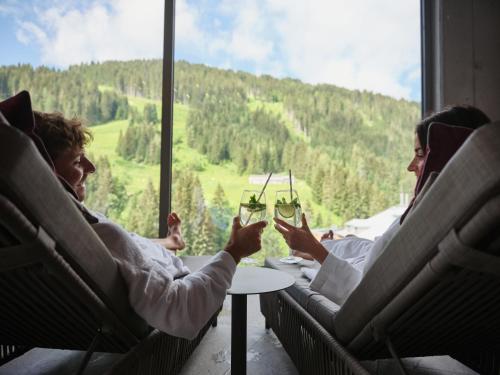 a group of people sitting in a train looking out a window at Sporthotel Wagrain in Wagrain