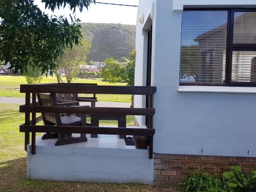 a wooden bench sitting on the side of a building at 4 On Hoffman Seaview in Agulhas