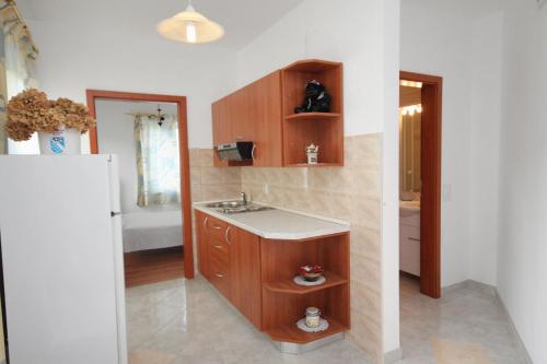 a bathroom with a sink and a counter top at Apartment Njivice 5458d in Njivice