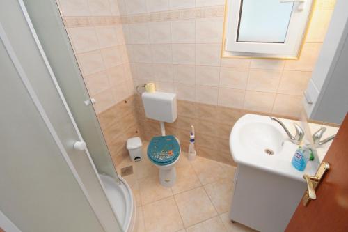 a small bathroom with a toilet and a sink at Studio Njivice 5458a in Njivice