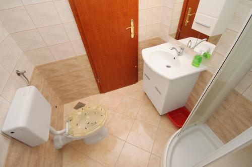 a small bathroom with a toilet and a sink at Apartment Njivice 5458f in Njivice