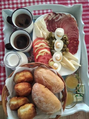a tray of food with different types of food on it at Apartments Stevovic in Žabljak