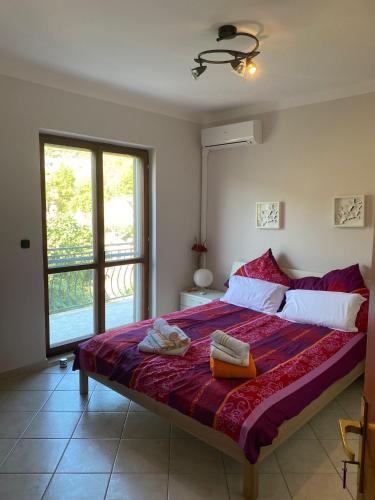 a bedroom with a large bed with towels on it at Strandhaus Roko in Preko