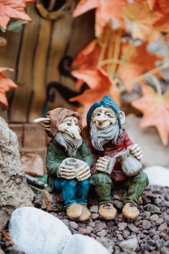 two figurines sitting on rocks in front of a building at Agriturismo le Fontane - Lago di Bolsena in Grotte di Castro