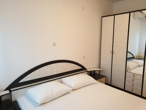 a bedroom with a bed and a large mirror at Triple Room Metajna 4120f in Metajna
