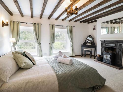 a bedroom with a large bed and a fireplace at Minafon in Oswestry