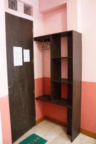 a room with a book shelf and a door at GV Hotel - Baybay in Baybay