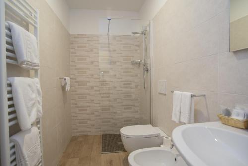 a bathroom with a toilet and a sink and a shower at Hotel Astoria in Ravenna