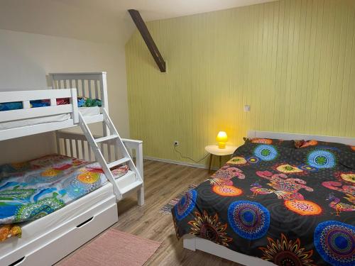 a bedroom with two bunk beds and a table at Mr. Bens cottage in Škofja Loka