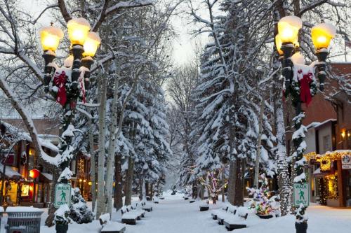 a snowy street with snow covered trees and lights at Seasons Four 172 Two bedroom plus loft in Snowmass Village