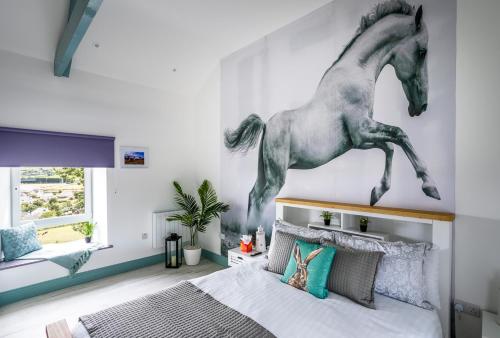 Curragh House في كينسالي: غرفة نوم مع جدارية خيول على الحائط