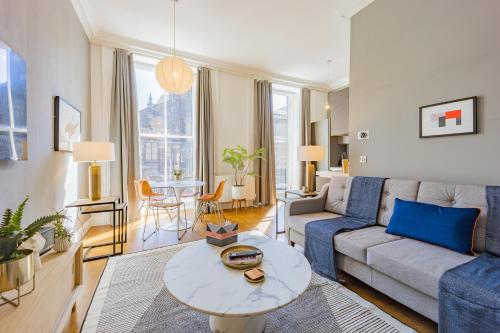 a living room with a couch and a table at No1 Apartments Edinburgh - George IV Bridge in Edinburgh